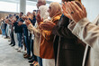 © Jacob Lund - Modern business team clapping at a conference, showcasing teamwork and diversity