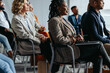 © Jacob Lund - Professionals focused on presentation at business meeting with diverse audience