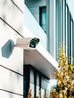 © id512 - HD outdoor security IP camera mounted on modern building facade, providing video surveillance and protection for residential or commercial property, vertical