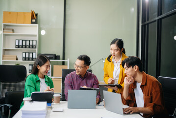 Wall Mural - Business teamwork and collaboration among Asian professionals in a modern office