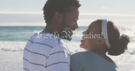 Wall Mural - Smiling couple on beach with long live the revolution text over animation