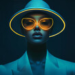 © Majce - Portrait of female fashion model wearing futuristic hat and glasses glowing neon on dark studio dark blue background