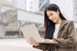 © dodotone - Business freelance asian woman using laptop computer sitting at outdoor