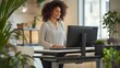 © doraclub - Woman using standing desk in modern office for improved ergonomics and wellness