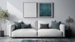 © svastix - A modern white couch is placed in front of a wall with two framed pictures, creating a stylish and comfortable seating area with a blend of minimalist aesthetics.