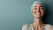 © svastix - A cheerful woman with a turquoise headscarf smiles delightfully against a plain backdrop. The image portrays joy and simplicity, highlighting her infectious enthusiasm.