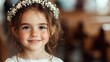 © svastix - A young girl with a beautiful flower crown and freckles smiles warmly at the camera, standing in an indoor setting with soft lighting, exuding innocence and joy.
