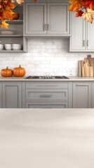 A cheerful Halloween pumpkin sits on a kitchen table adorned with festive decorations and garland, capturing the spirit of the season in a cozy atmosphere