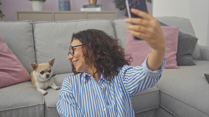 Sticker - A middle-aged woman takes a selfie with her chihuahua in a cozy living room setting.