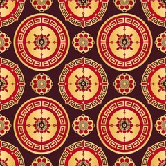 Ornate gold and red pattern with repeating circular designs.