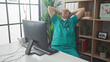 © Krakenimages.com - Hispanic male doctor in scrubs relaxing in hospital office with computer and stethoscope