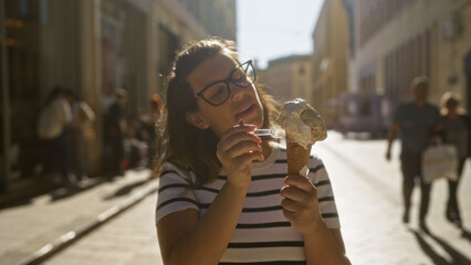 Wall Mural - A young hispanic woman enjoying ice cream on a sunny day in lecce, a historic town in puglia, italy.