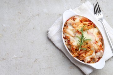 Poster - Delicious al forno pasta in baking dish on light table, top view. Space for text