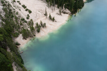 Wall Mural - aerial view of the sandy path that runs along the braies leke in trentino alto adige italy