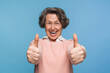 © InsideCreativeHouse - Mature satisfied happy smiling caucasian woman female pensioner in casual clothes showing two thumb up like gesture isolated on blue color background studio portrait. People lifestyle concept