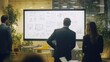 © elimicel - Empower Your Teams to Work Together More Effectively. A Female Business team leader present on new business workflows with her team for brainstorm ideas to manage customer project