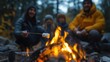 © GulArt - Closeup of a family gathered around a campfire roasting marshmallows while camping in the Autumn time among forest
