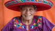© Erika - Elderly Hispanic Woman in Colorful Traditional Hat and Embroidered Blouse Smiling Warmly
