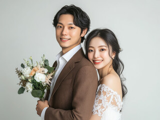 Wall Mural - A Japanese couple posing for wedding photos. The man is wearing an elegant brown suit and white shirt, with his head tilted back while holding flowers in one hand.