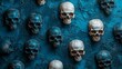 © Barosanu - Multiple human skulls are artistically arranged on a textured blue background, creating a macabre yet visually interesting pattern suitable for spooky designs.