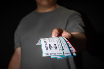 Close-up of a hand taking three tickets from a pocket,Ticket Scalping concept