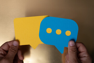 Two speech bubbles one yellow and one blue representing a conversation Let s chat