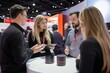 © DK_2020 - Product demo at a tech expo with curious attendees, interactions, tech showcase, innovation spotlight