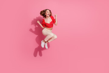 Canvas Print - Full length photo of lovely teen lady look empty space winning jump dressed stylish red garment isolated on pink color background