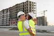 © Studio Peace - Portrait of a father and daughter in protective helmets on the background of a construction site.