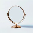 © MIN_NK - A classic round tabletop mirror with a gold finish and a swivel base.