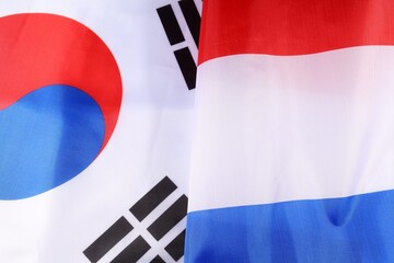 Flags of South Korea and the Netherlands displayed together indoors