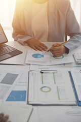 Wall Mural - Close up of Business team analyzing income charts and graphs with modern laptop computer. Business analysis and strategy concept.