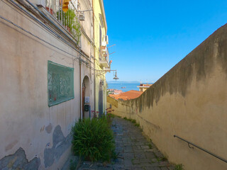 Narrow street in Naples under a blue sky