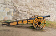 © Kai Beercrafter - cannon on a long wooden base, a defensive weapon of the fortress against the background of a stone wall