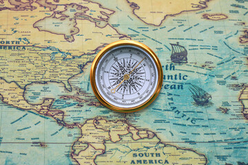 classic round compass on background of old vintage map