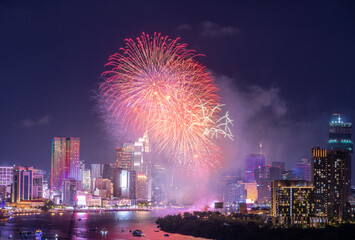 Wall Mural - Celebration. Skyline with fireworks light up sky over business district in Ho Chi Minh City ( Saigon ), Vietnam. Beautiful night view cityscape.