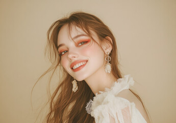 A young woman with long hair, fair skin, and delicate makeup stands in front of the camera wearing white , white earrings on her ears, against a beige background.