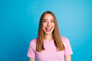 Poster - Photo portrait of pretty young girl lick teeth look empty space wear trendy pink outfit isolated on blue color background