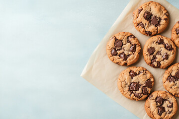 Top view of chocolate chip cookies on a solid background.