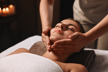 Wall Mural - Attractive woman enjoying face massage, closeup. Beauty procedure