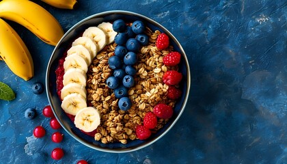 Vibrant acai bowl with banana, granola, and blueberries on dark stone, promoting healthy organic breakfast and superfood eating lifestyle