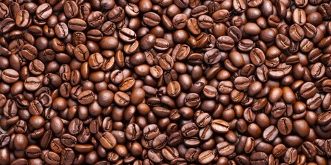 A textured close-up of freshly roasted coffee beans, showcasing their rich aroma and deep brown color against a rustic background