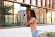 © ADDICTIVE STOCK - Young woman photographing campus with digital camera