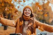 © Halina Berah - Bicycle ride in autumn park under falling leaves by a young, beautiful woman.