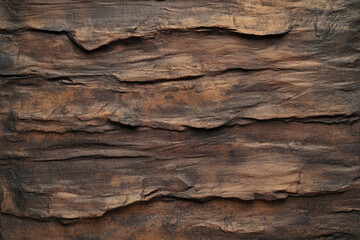 A brown textured surface with a rugged, hand-hewn finish, reminiscent of carved wood, with deep, irregular patterns.