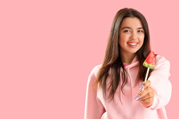 Sticker - Beautiful happy young woman with watermelon lollipop on pink background