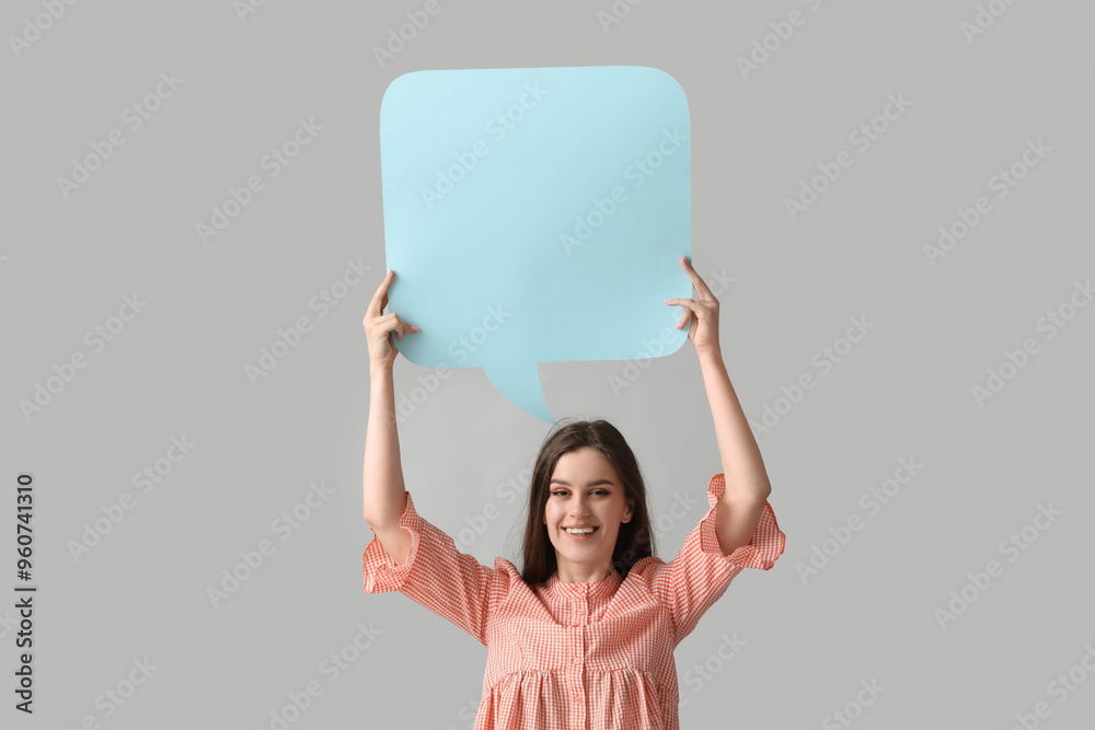 Beautiful happy young woman with speech bubble on grey background