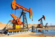 © Perecciv - silhouette of oil industrial pump in the desert against the sunset, stock quotes chart,