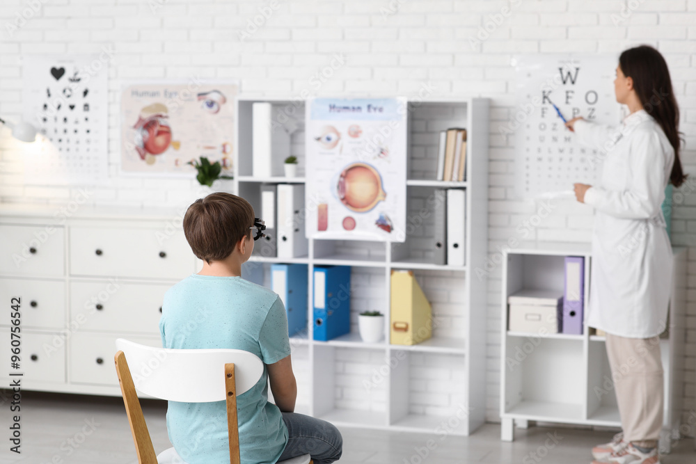 Ophthalmologist examining little boy in clinic