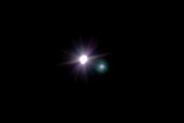 Wall Mural - star shaped lens flare on black background.